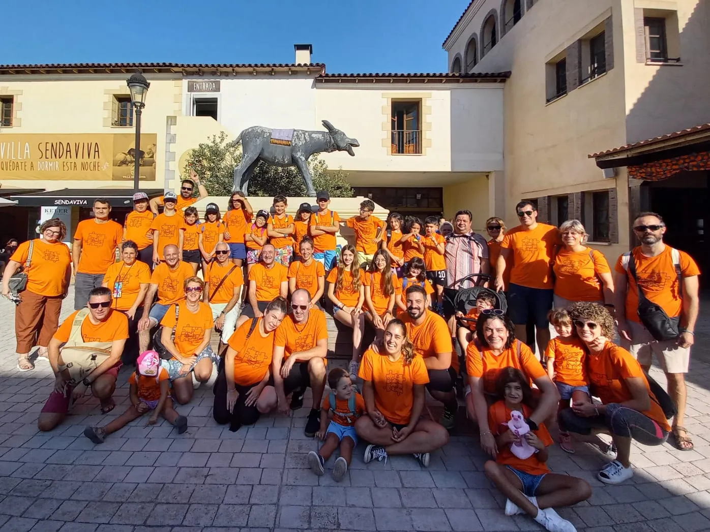 Foto de grupo de las familias con camisetas naranjas